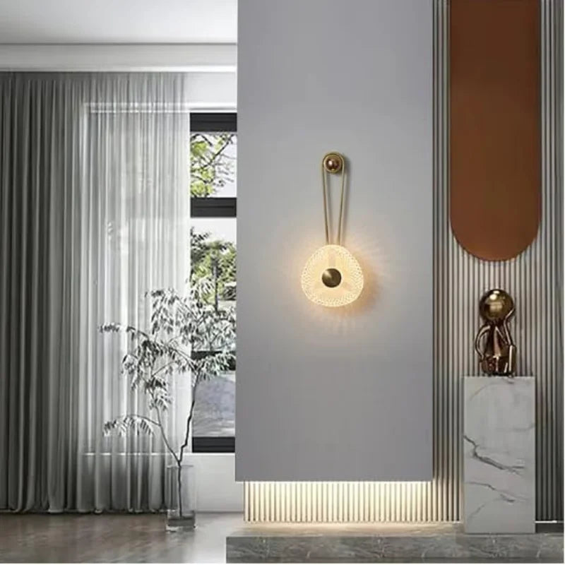 Modern-black-and-gold-wall-light-above-side-table

